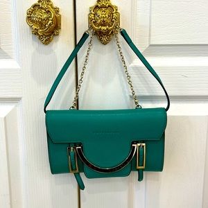 Beautiful Kelly green Coccinelli cross body/clutch with gold hardware.